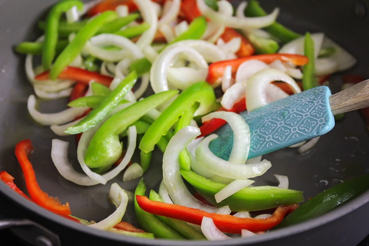 Peppers and onions cooking for Chicken Fajitas.