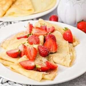 Crepes topped with fresh strawberries.