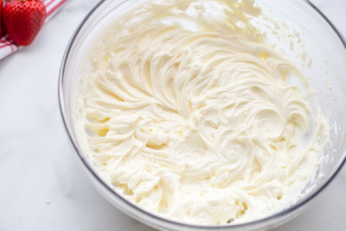 Cream cheese layer whipped in a glass bowl.