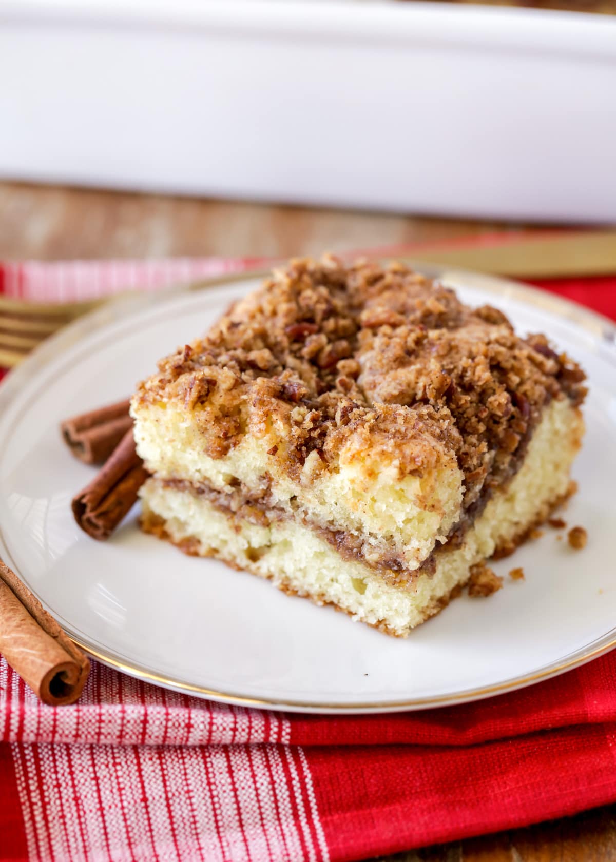 Sour Cream Coffee cake recipe sliced and served on a white plate.