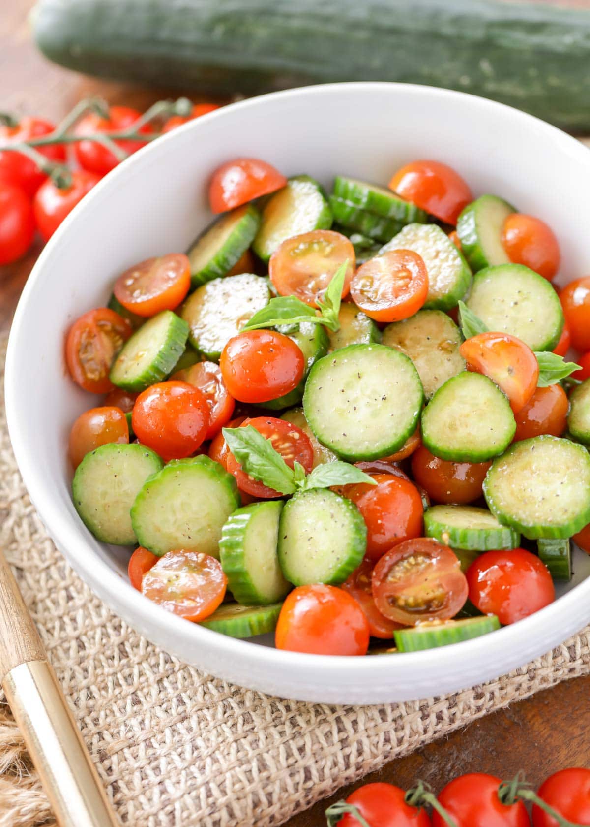 Fresh Cucumber Tomato Salad lightly dressed and served in a white bowl.