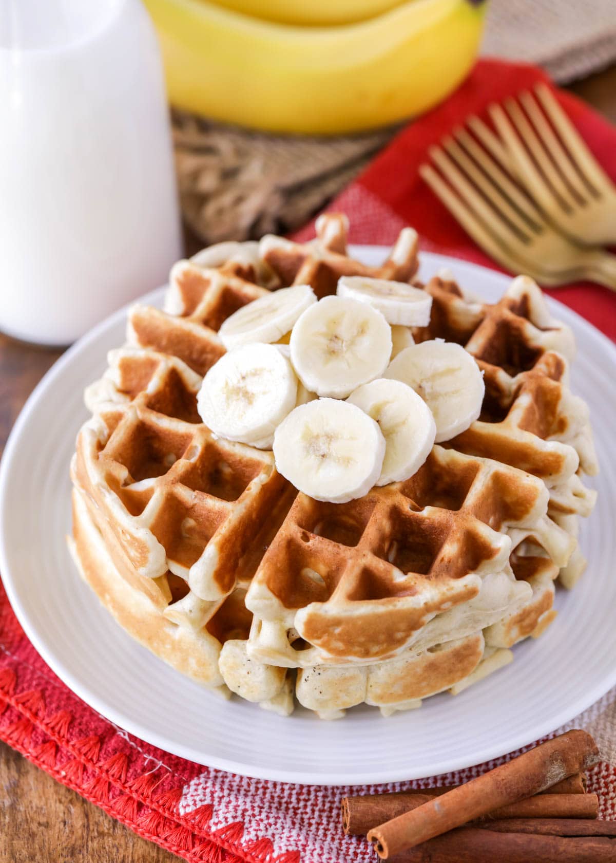 Stack of banana waffles on a white plate