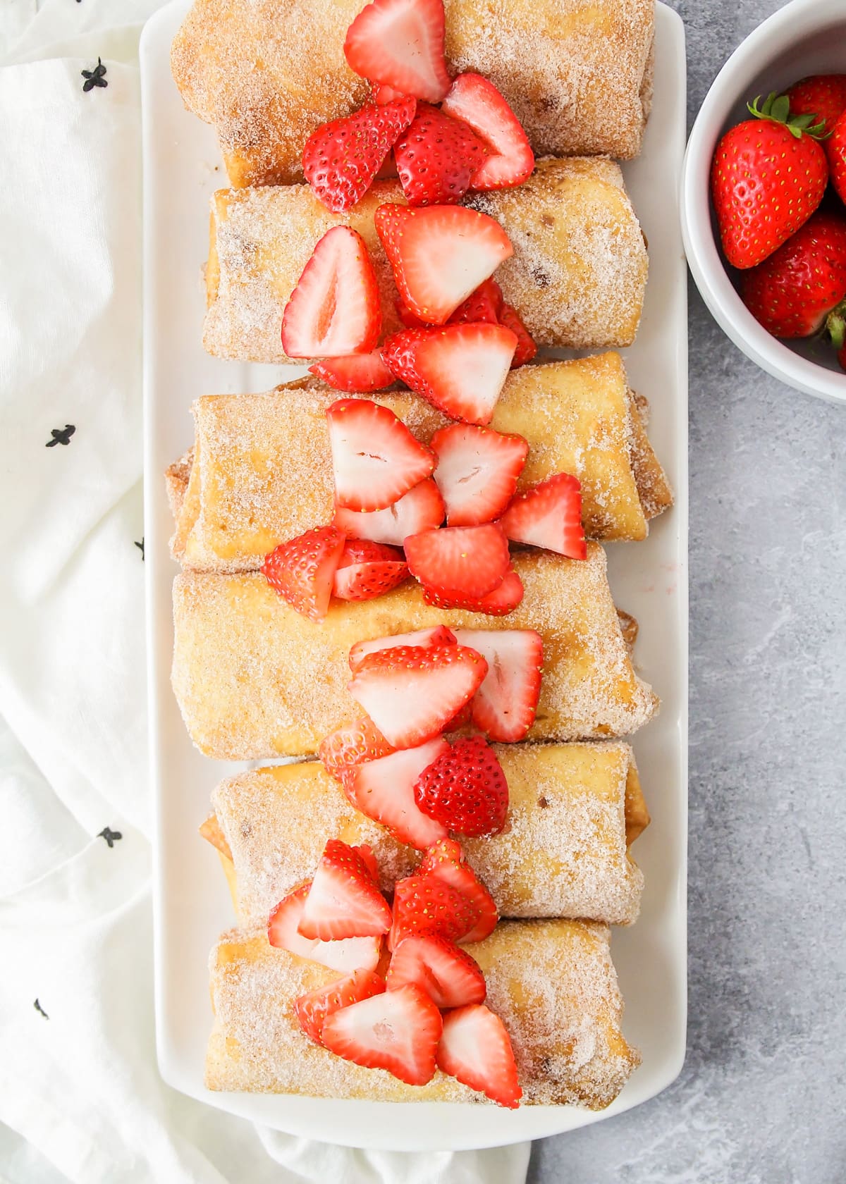 White tray filled with strawberry cheesecake chimichanga recipe.