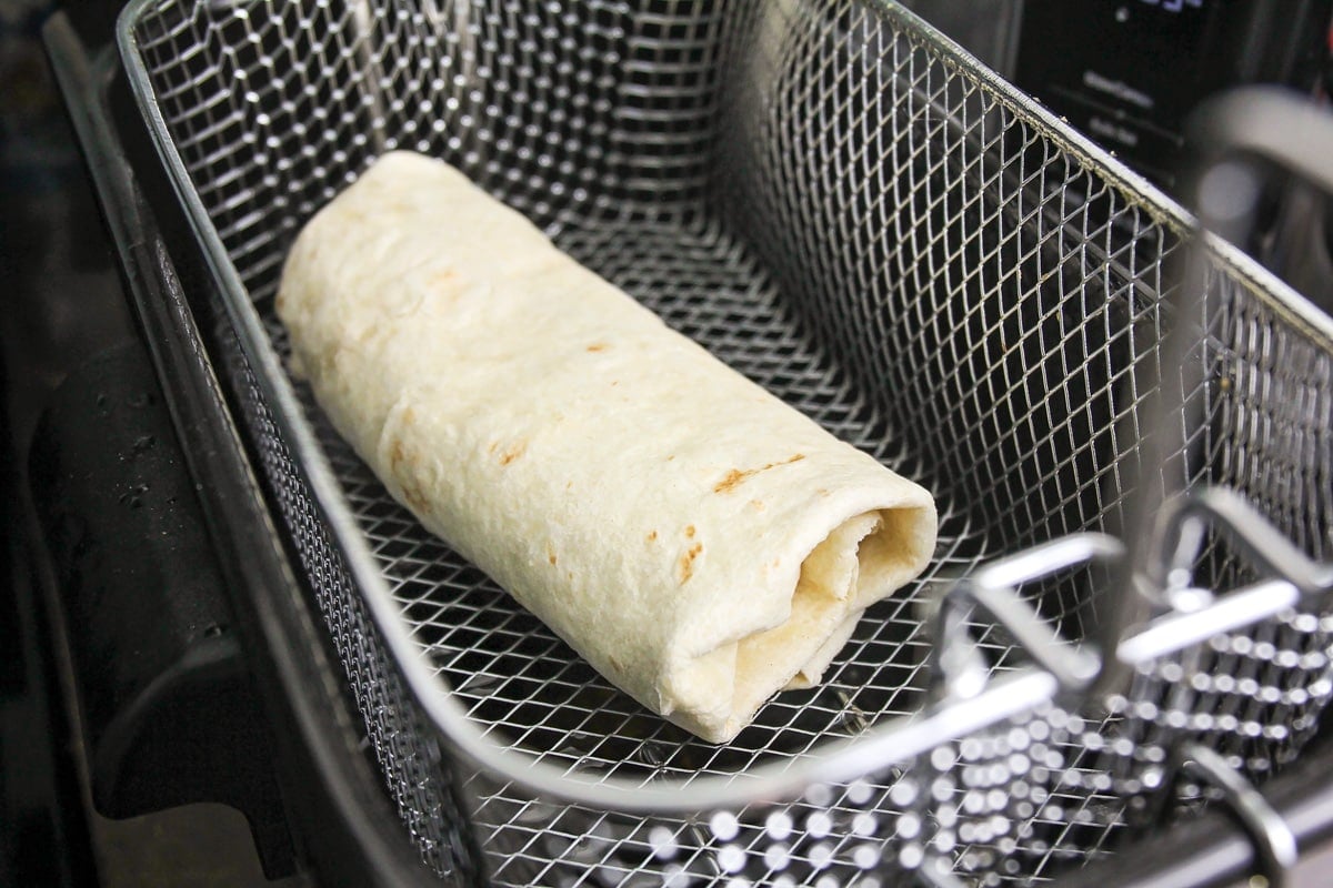 A wrapped burrito ready to be fried.