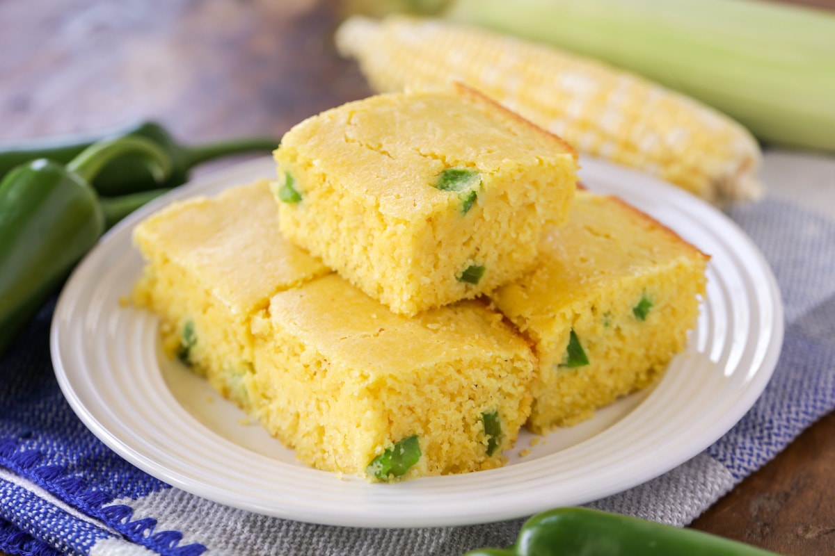 White plate topped with squares of jalapeno cornbread
