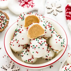 A bowl of peanut butter snowballs with one cut in half.