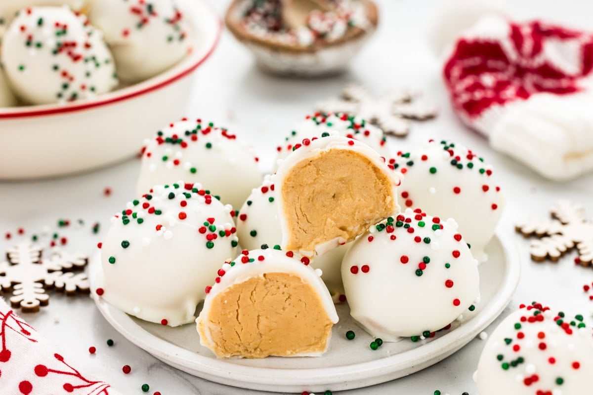 Several peanut butter snowballs with one broken in half.