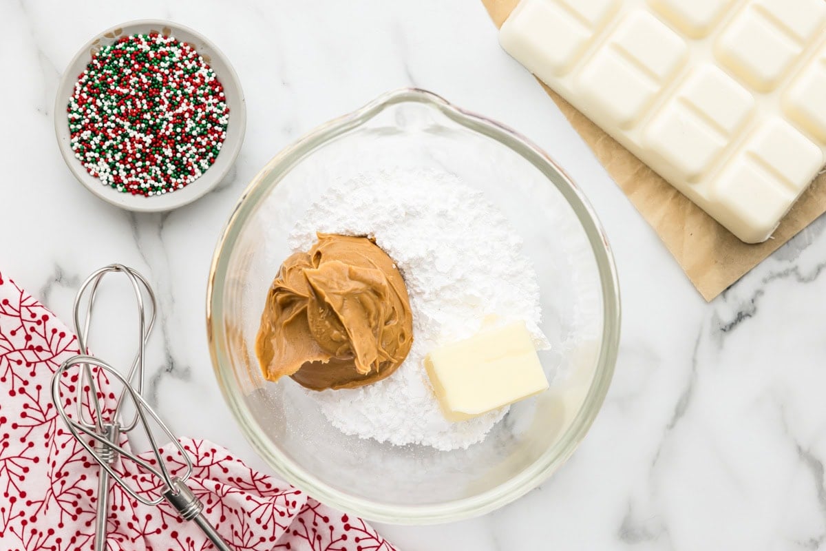 Combining ingredients for peanut butter snowballs.