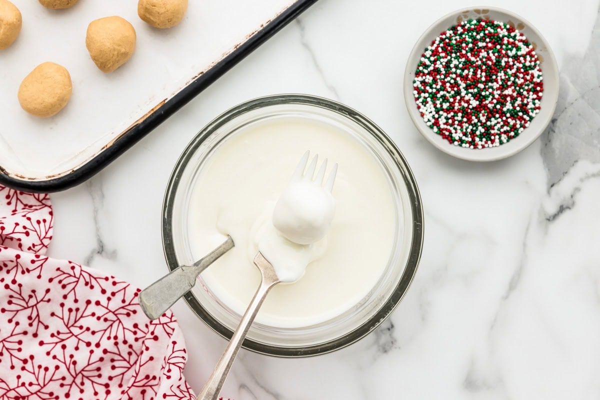Dipping peanut butter snowballs in candy melts.