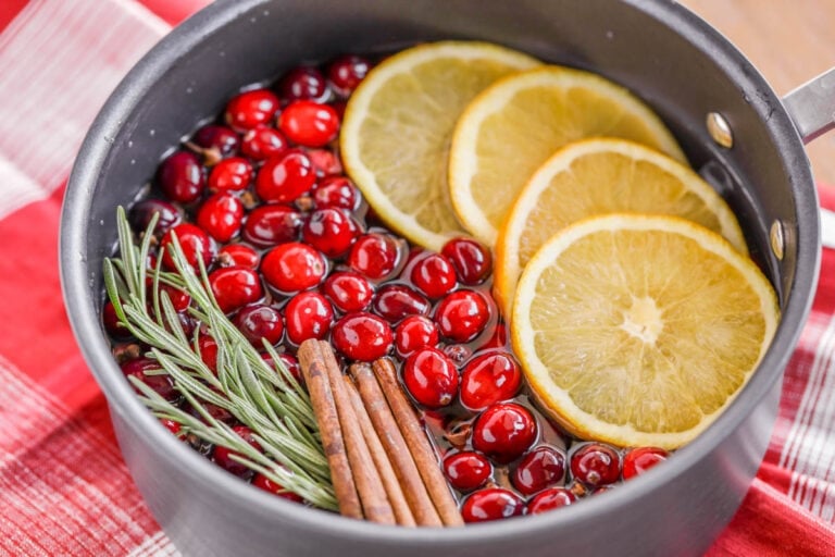 Stovetop potpourri filled with oranges, cranberries, rosemary, and cinnamon.