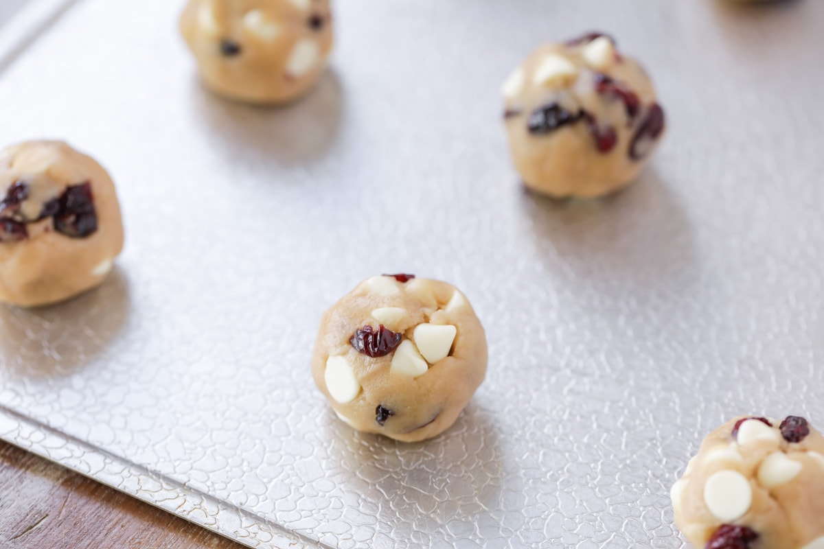 Balls of white chocolate cranberry cookies dough