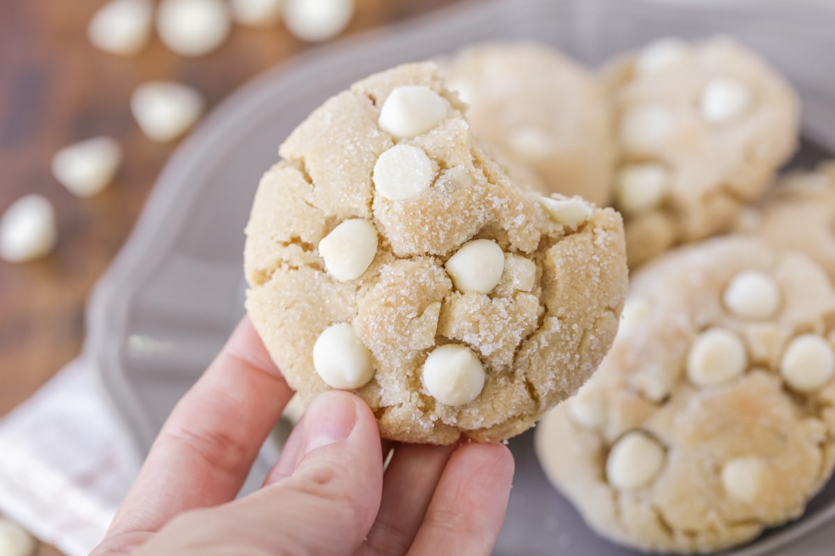 Bite out of a white chocolate crackle cookie