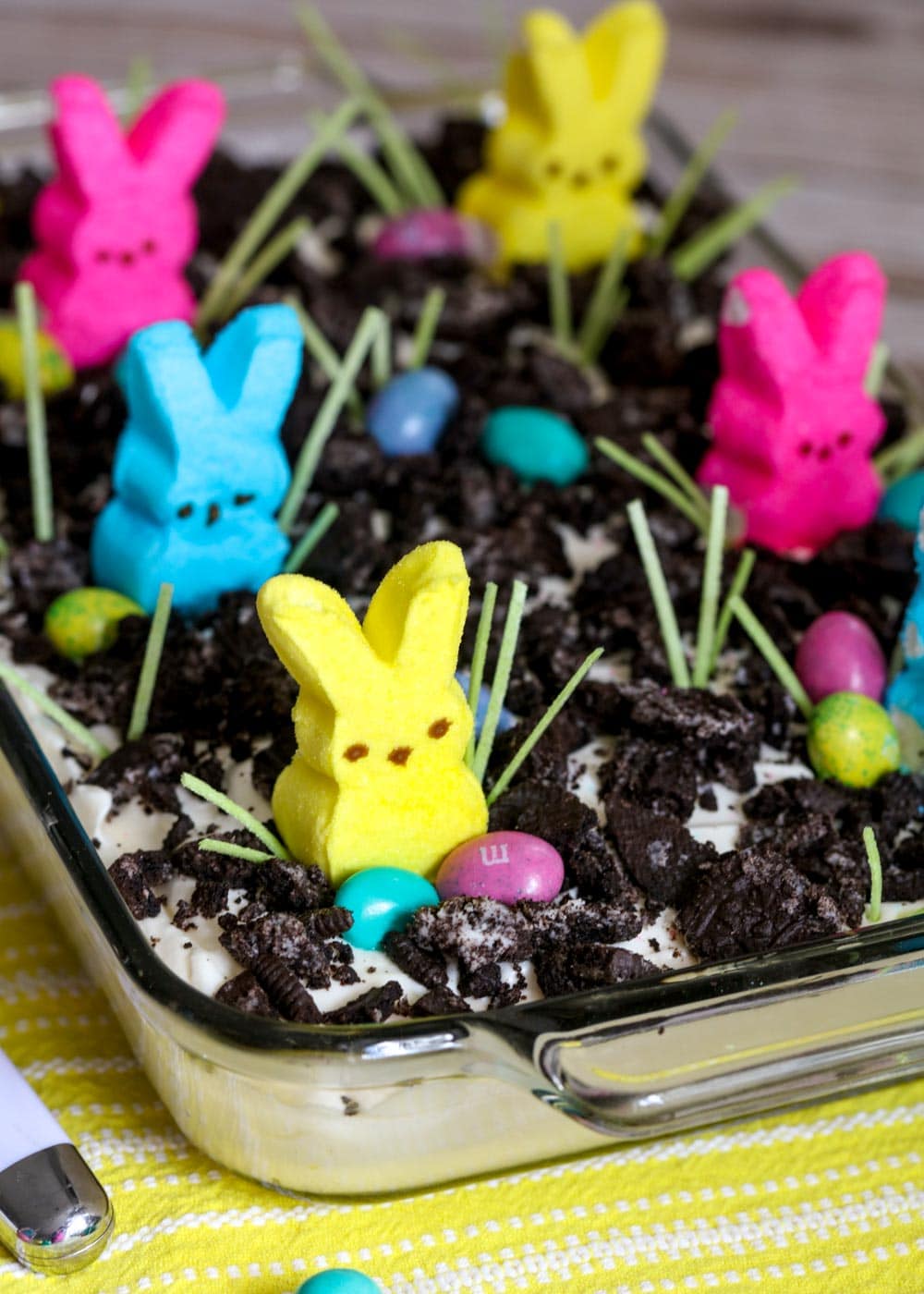 Easter Dirt Cake with peeps and M&Ms sprinkled on top.
