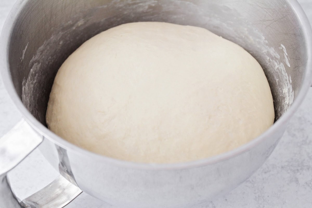 Bread dough rising in a bowl.