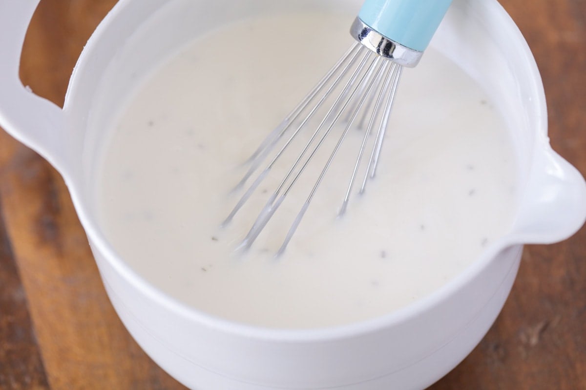 Mayo sauce for Chicken macaroni salad in a white bowl.