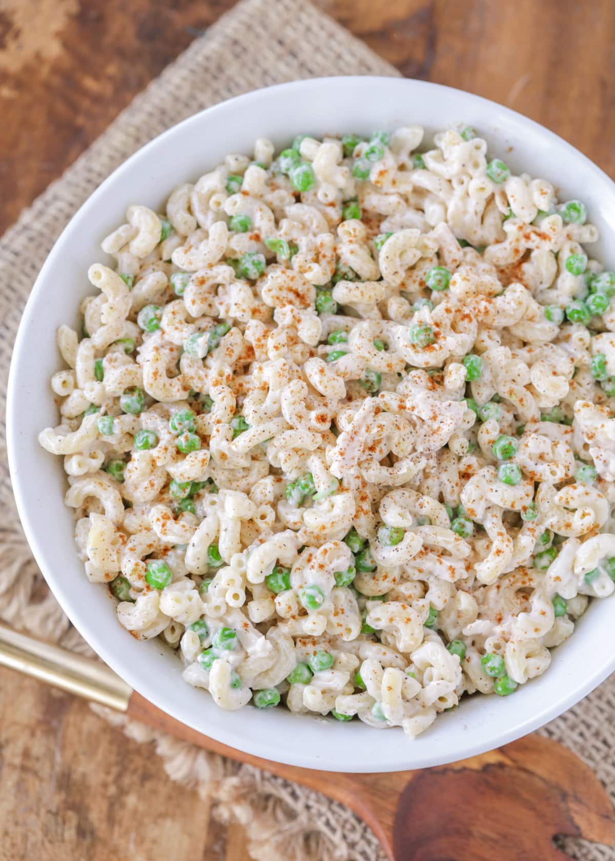 White bowl filled chicken macaroni salad.