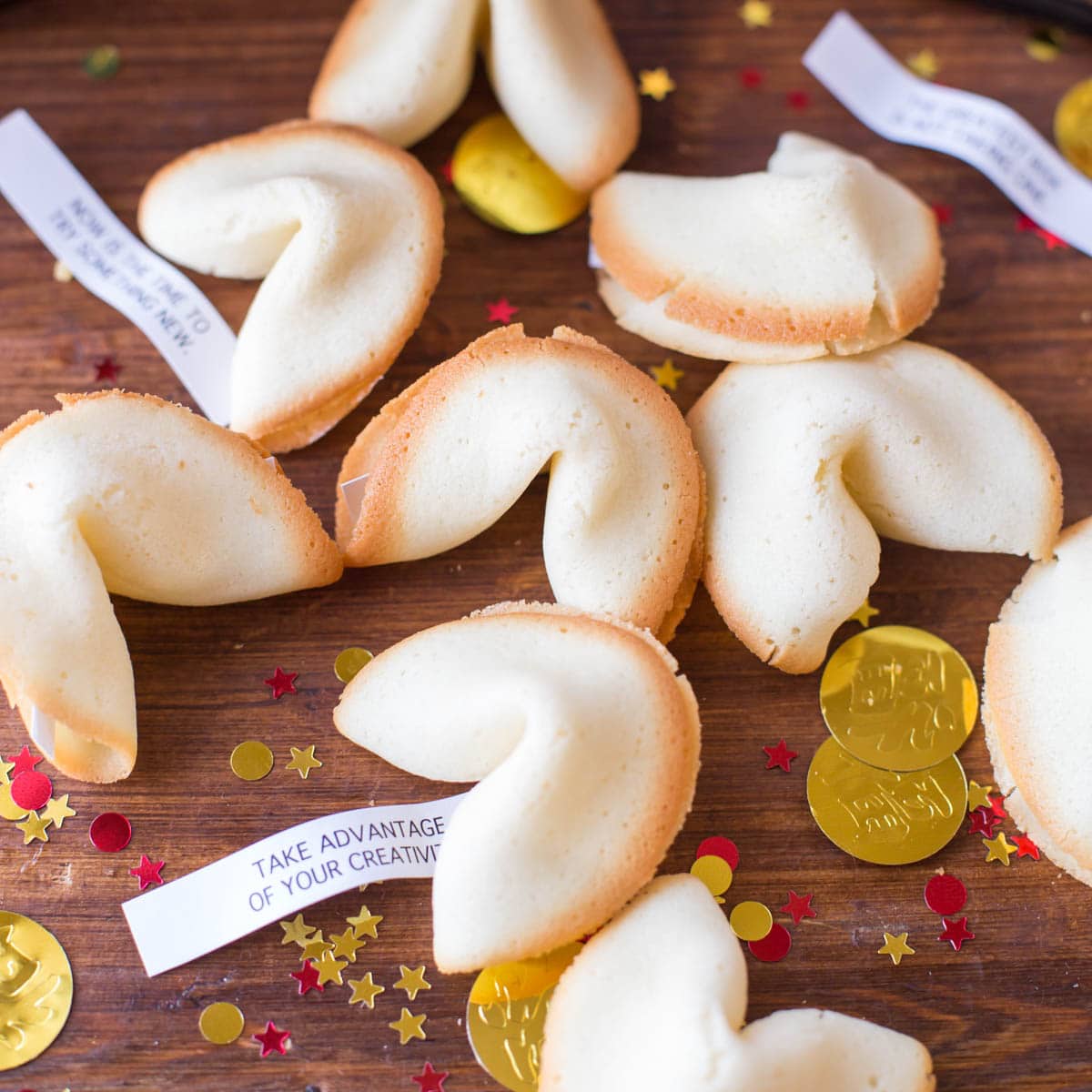 Fortune cookie recipe with fortunes sticking out on a wooden table.