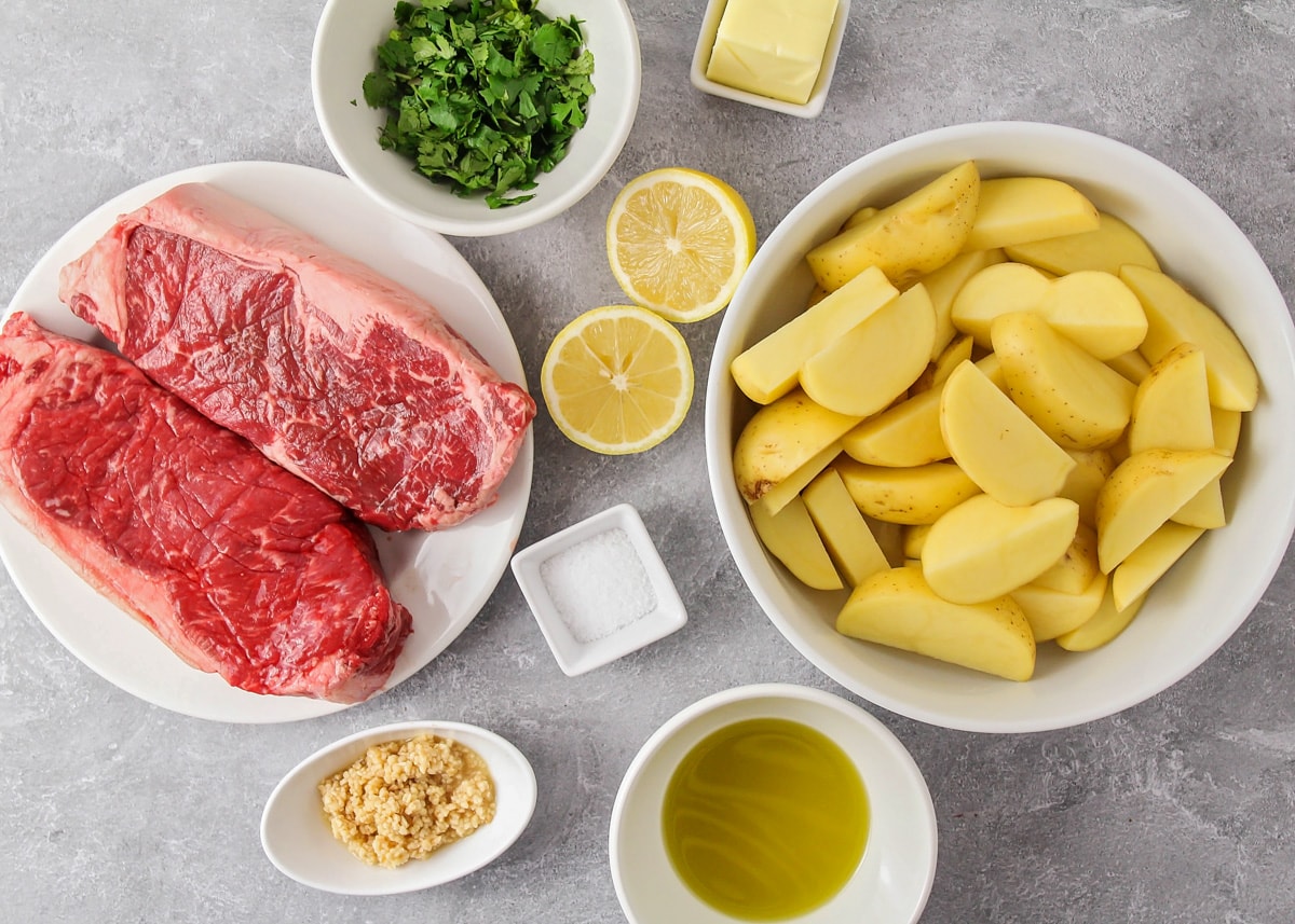 Steak and other ingredients needed for one skillet steak and potatoes.