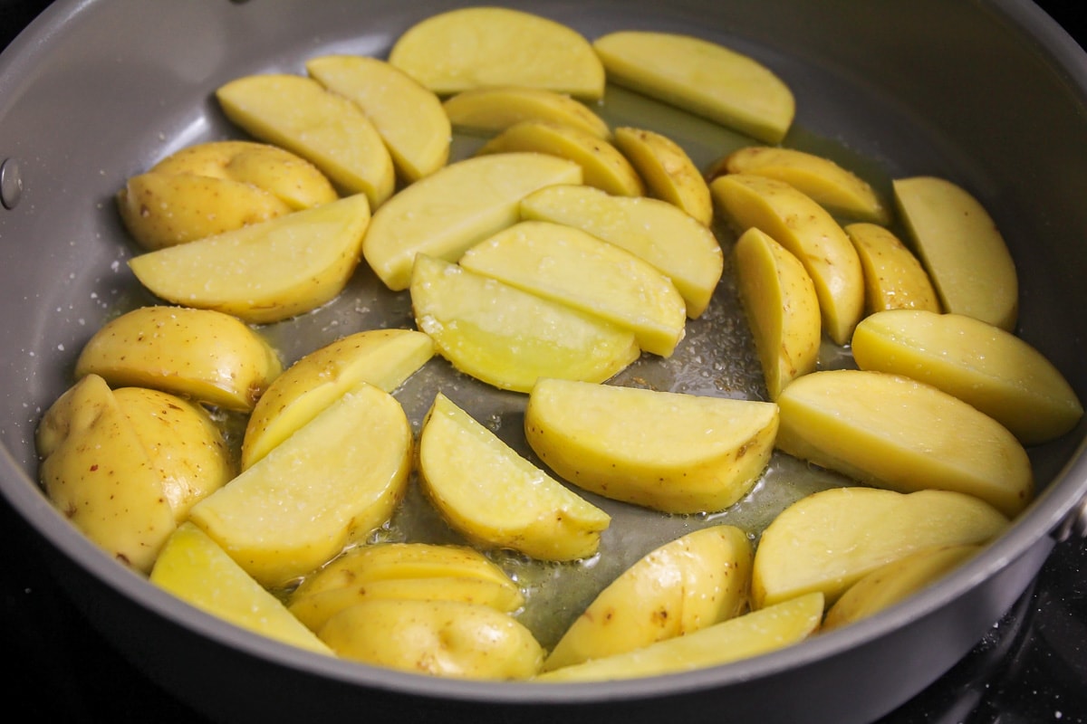 Browning potato wedges in olive oil for steak and potatoes.