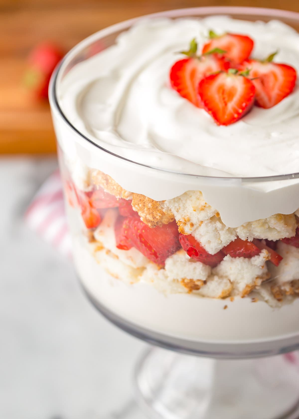 Close up of complete strawberries and cream angel food cake trifle topped with fresh berries.