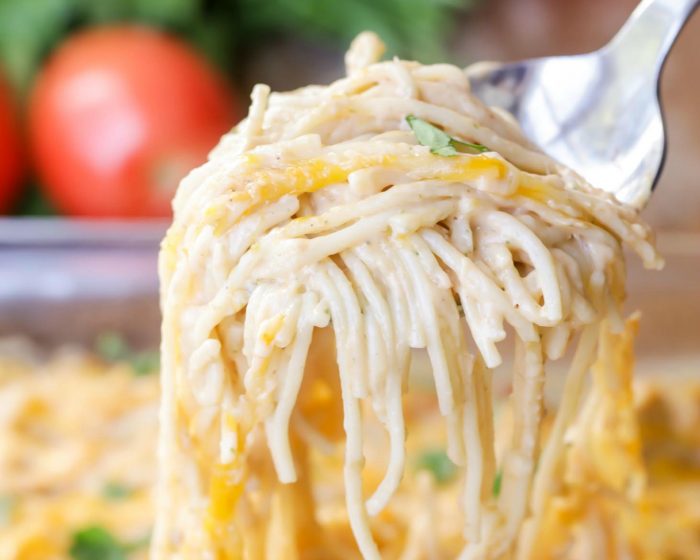Chicken Pasta Recipes - A spoon scooping some chicken spaghetti out of a casserole dish.