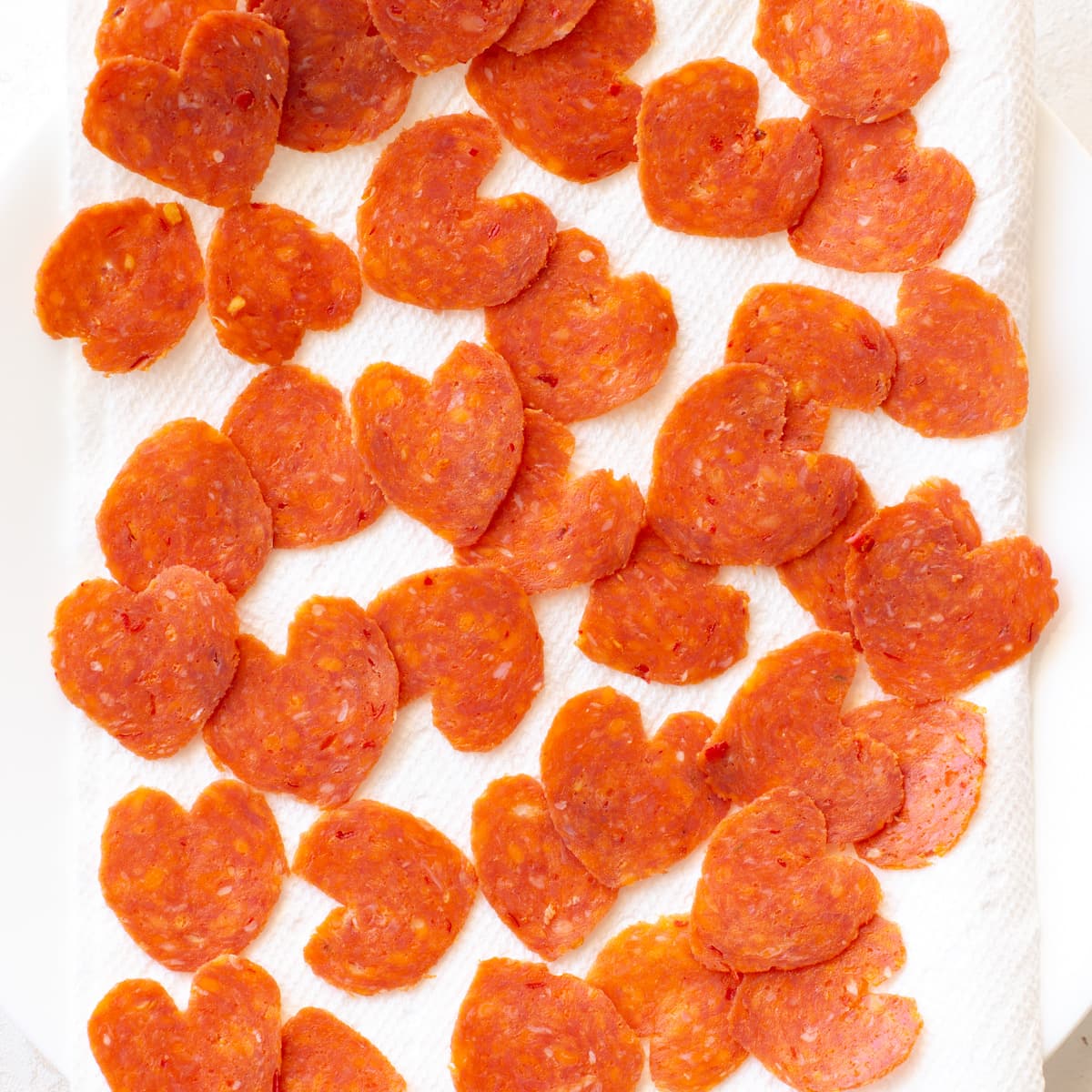 Heart shaped pepperoni on paper towel for Heart Shaped pizza.