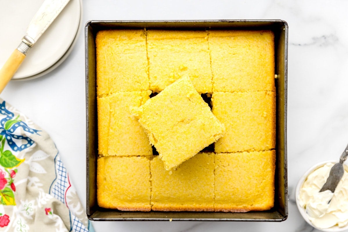 Sliced buttermilk cornbread in a square pan.