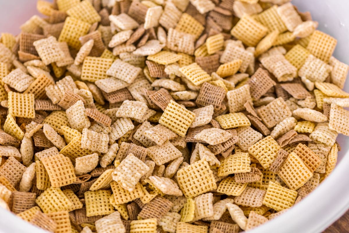 Chex mix cereal pieces in a white bowl.