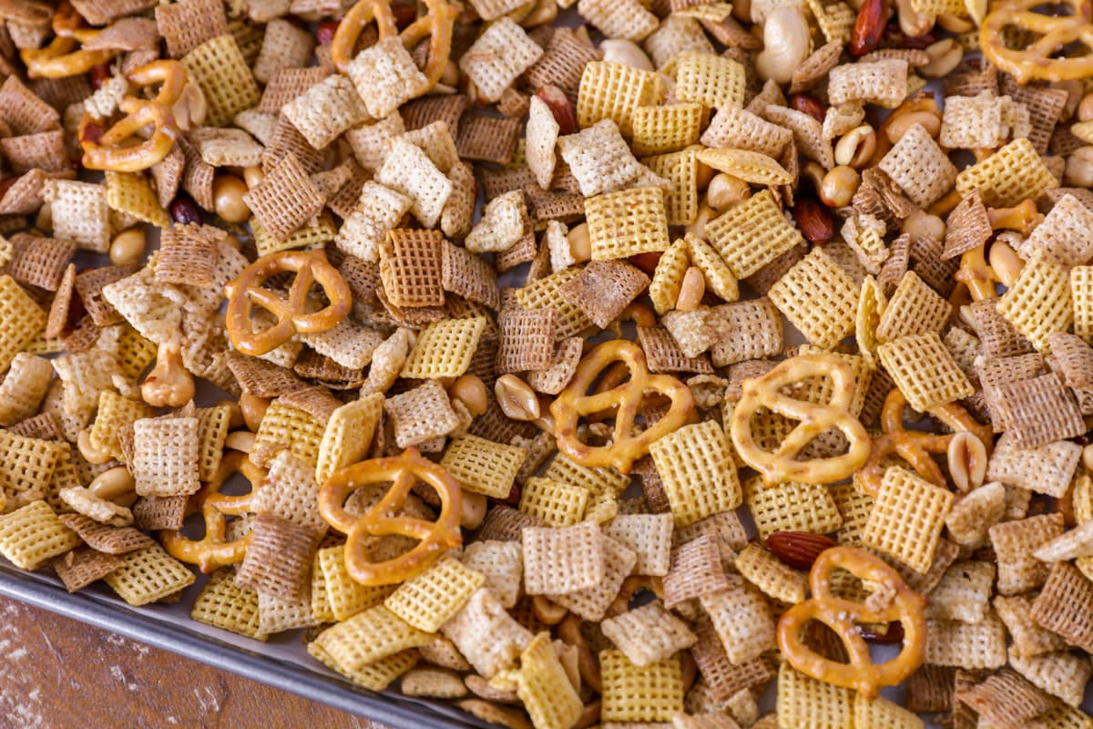 Chex mix spread on a baking pan.