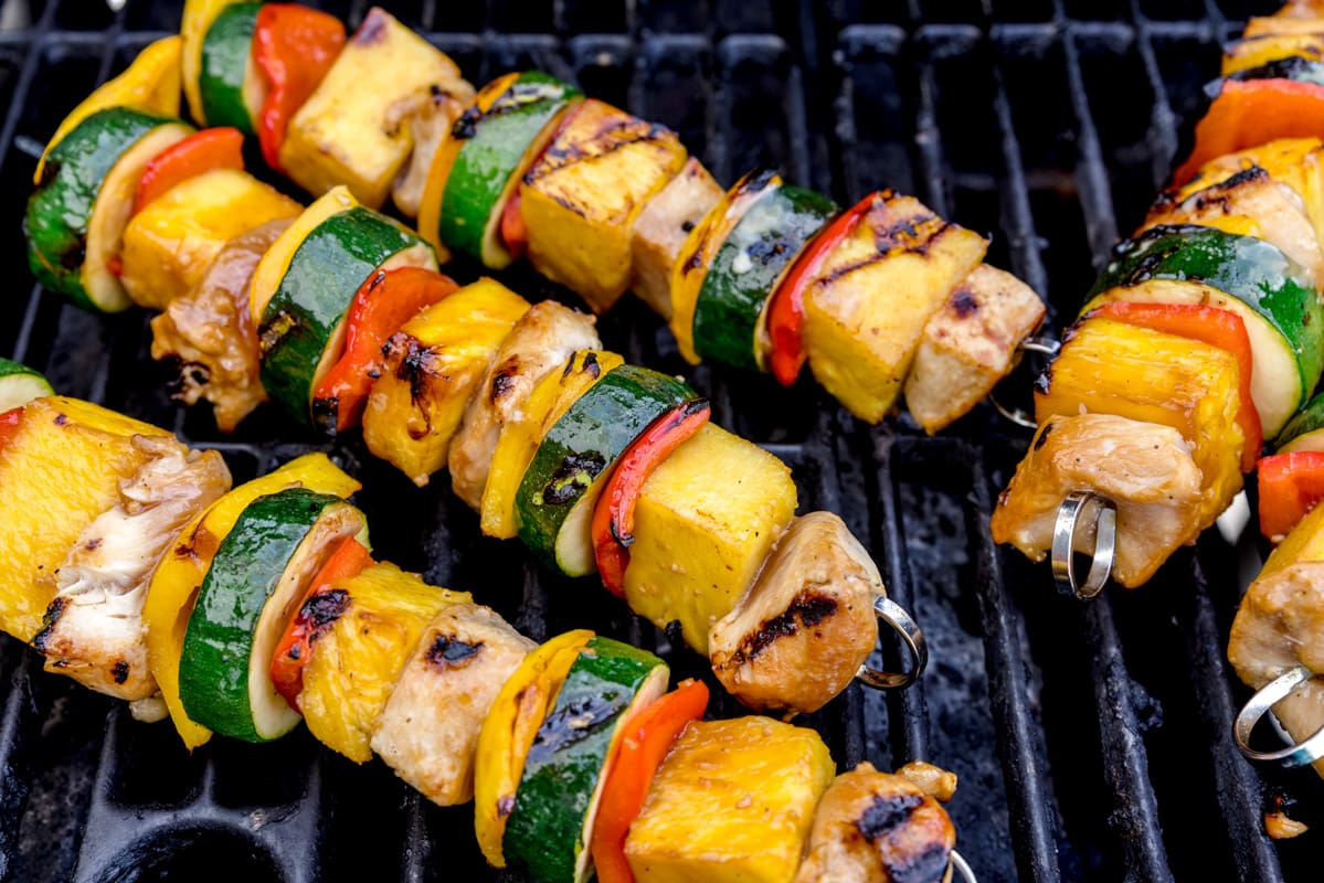 Grilled dinner ideas - chicken kabobs cooking on a grill.