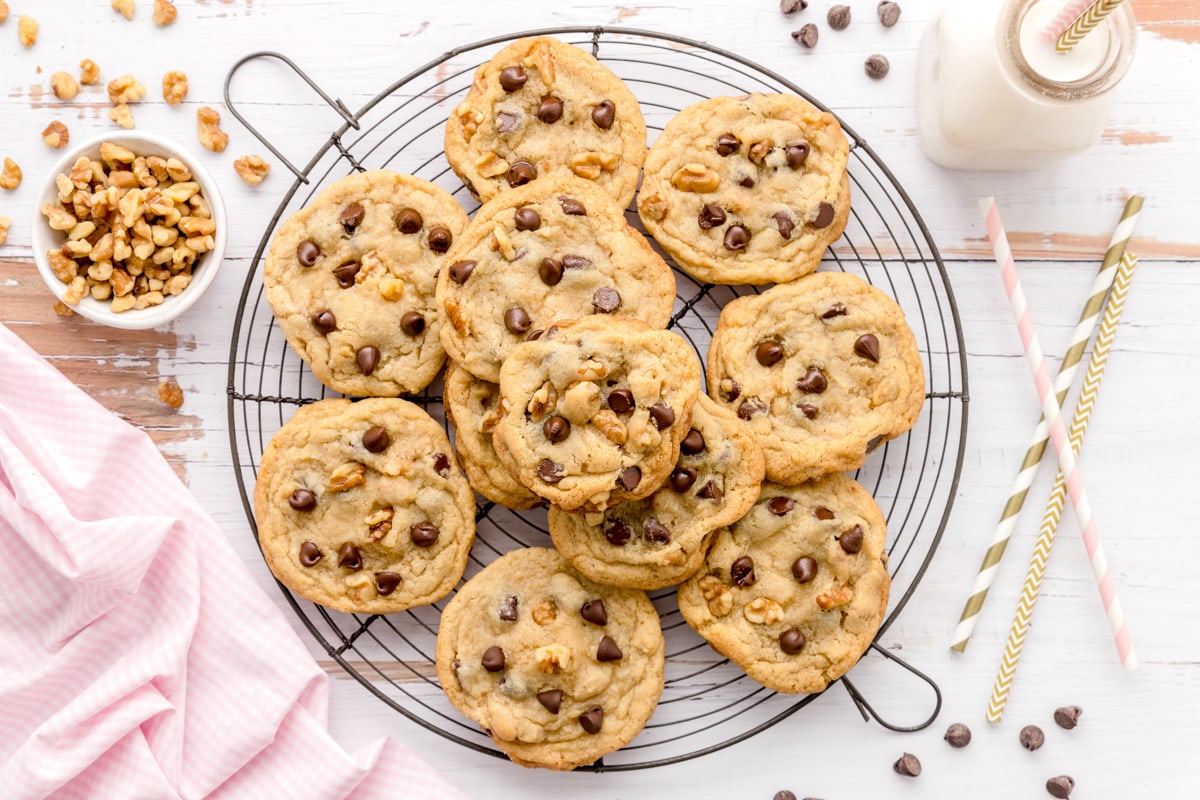 Stacked chocolate chip walnut cookies on a cooling rack.