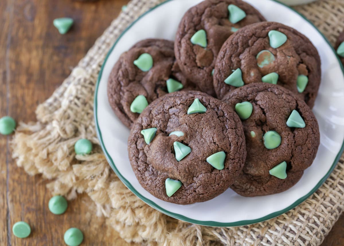 Several chocolate mint cookies on a white plate.