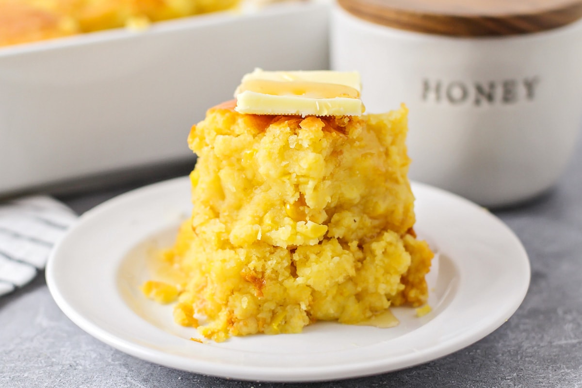 stacked cornbread casserole topped with honey and butter