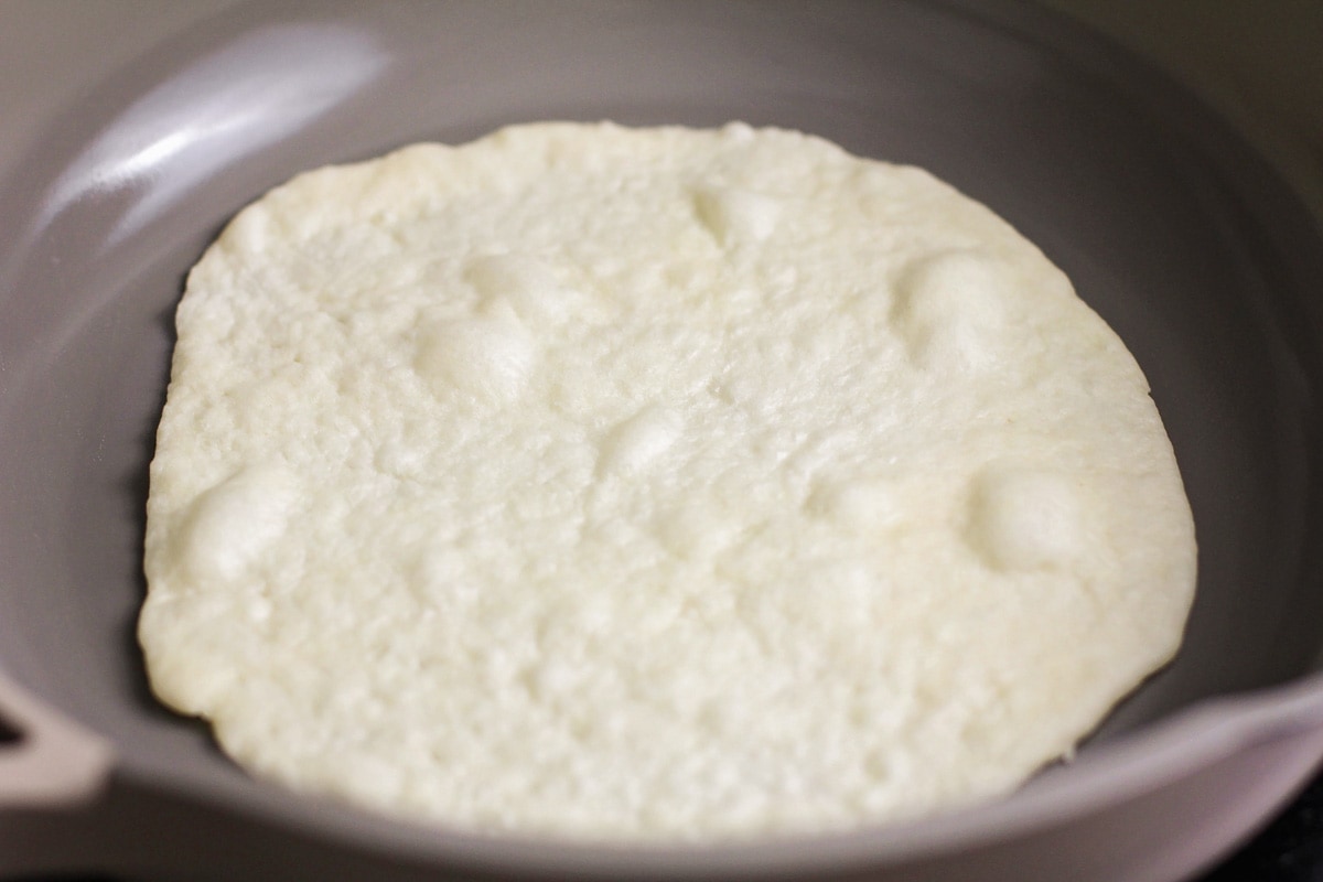 Homemade flour tortillas being cooked on skillet