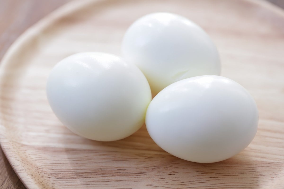 Hard boiled eggs sitting on a plate.