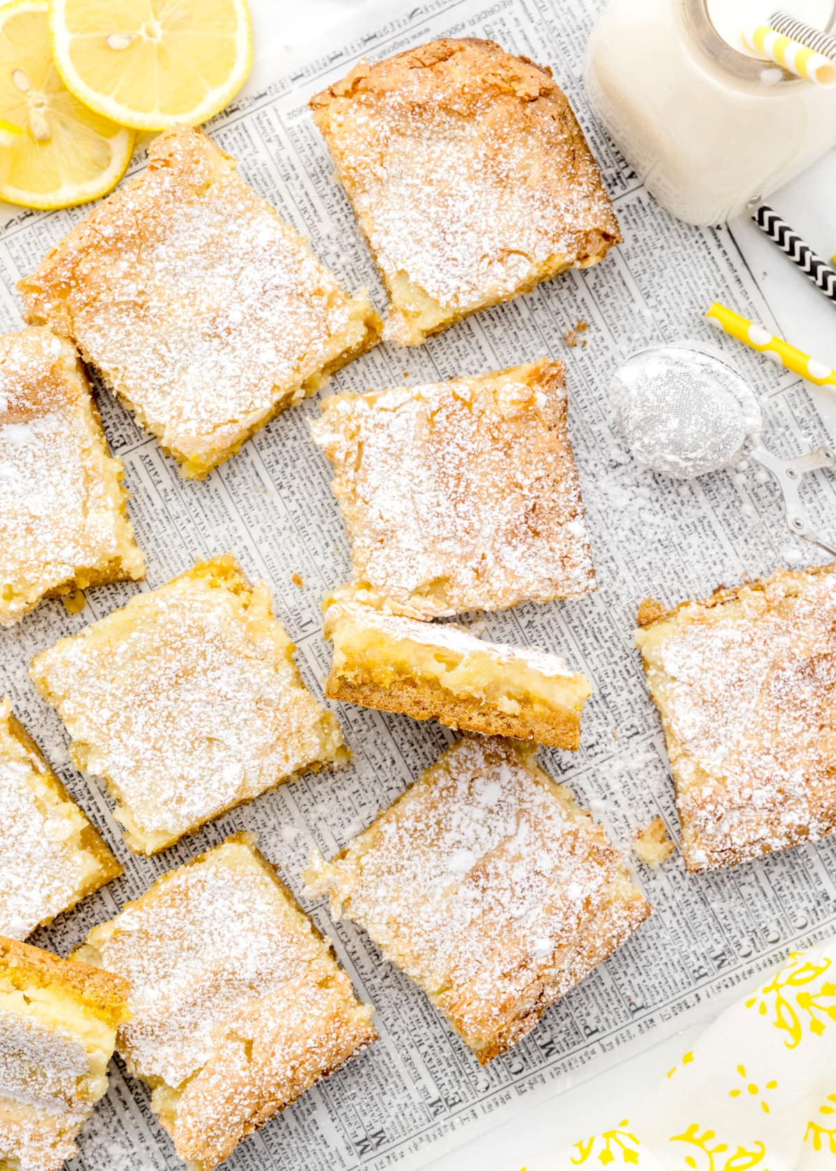 squares of lemon bars with cake mix on a newspaper, served with milk