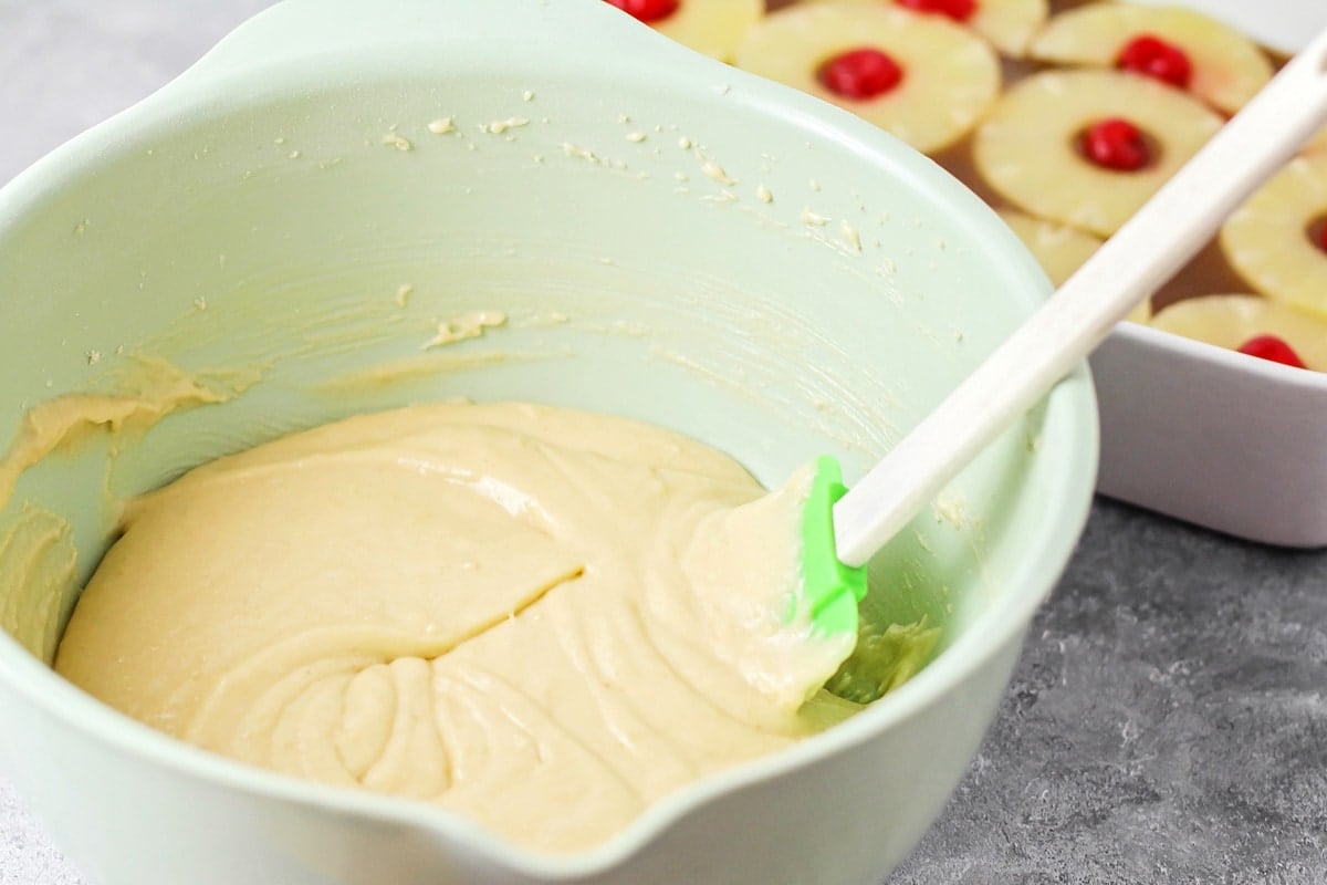 Batter for cake in a mint bowl.