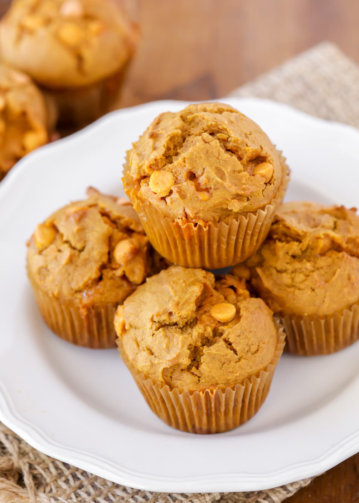 Stacked pumpkin butterscotch muffins recipe on a white plate.