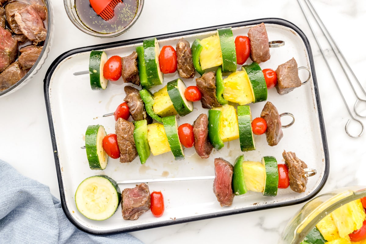 Prepping steak kabobs for grilling.