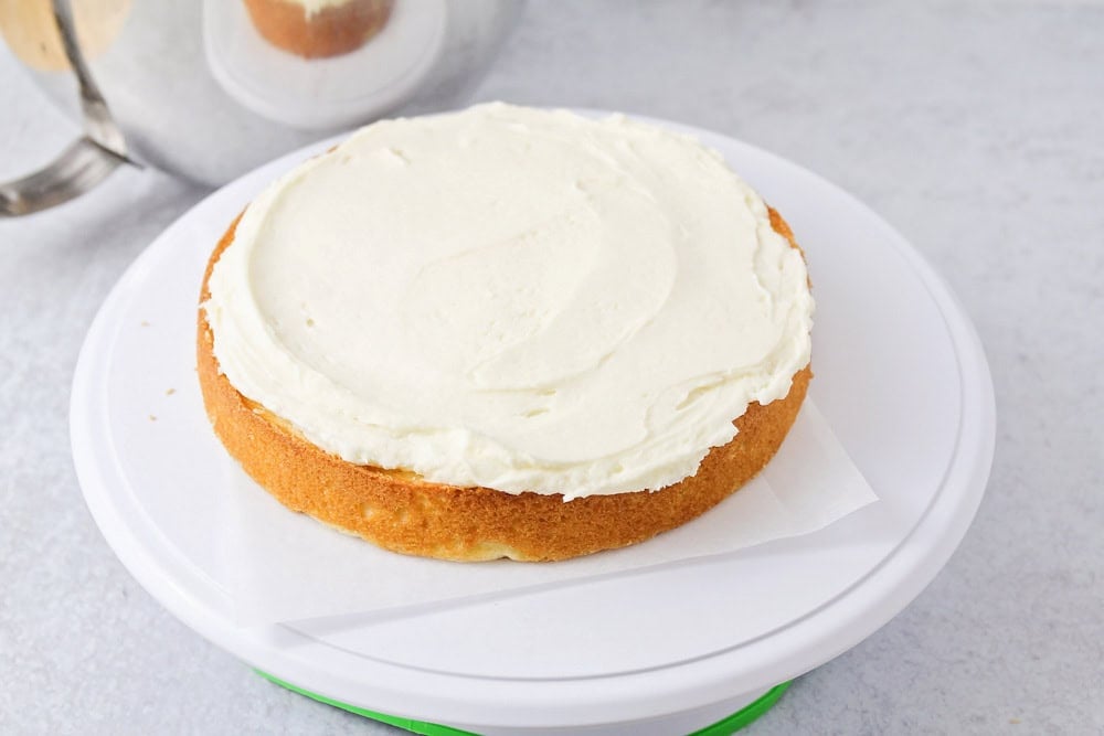 Vanilla cake layers started on cake stand.