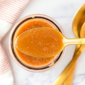 Homemade caramel sauce in a spoon.