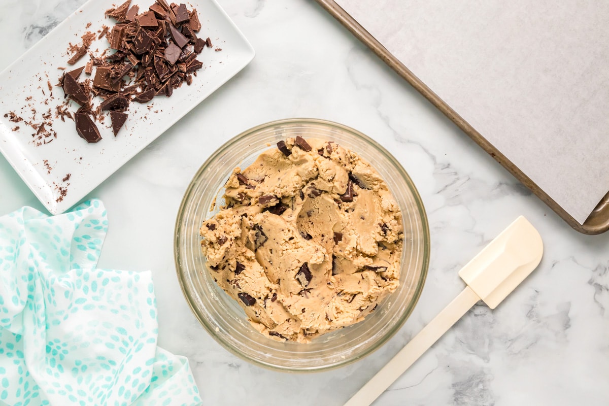 Glass bowl of chocolate chunk cookie dough.