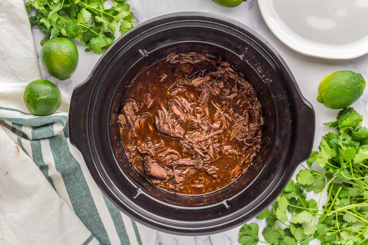 Shredded beef slow cooker barbacoa cooked in juices.