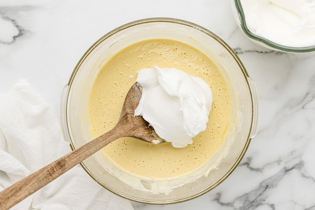 Adding egg whites to the cake batter.