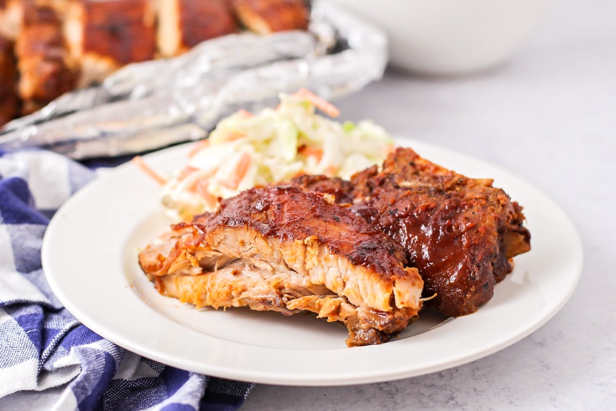 Plate of baby back ribs served with coleslaw.
