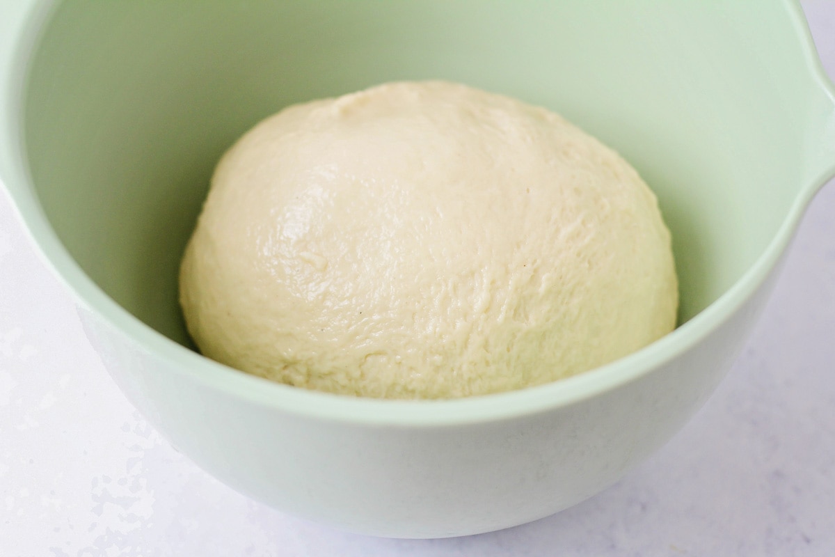 Beignet dough in mint bowl.