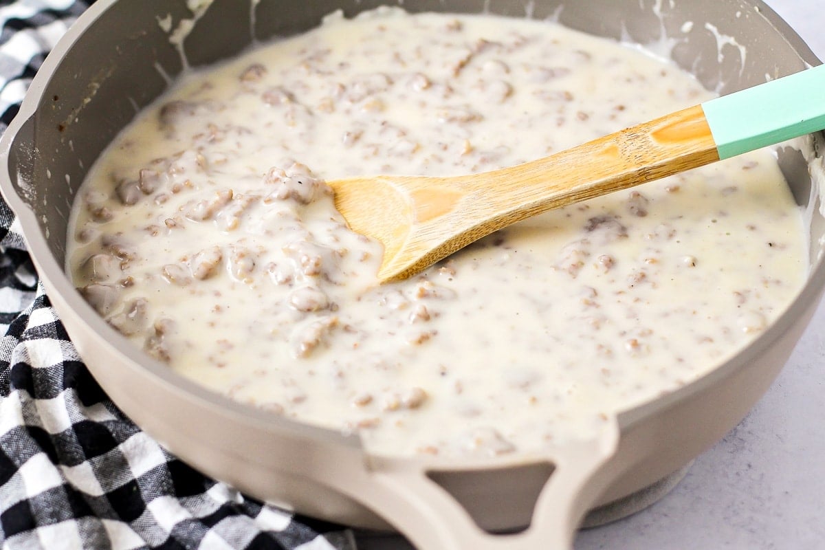 Cooking biscuits and gravy sauce in a skillet.