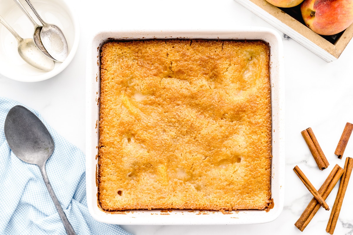 Peach Cobbler recipe fresh from oven in baking dish.