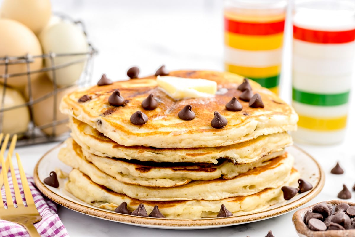 Stack of 5 fluffy buttermilk chocolate chip pancakes served with a pat of butter.