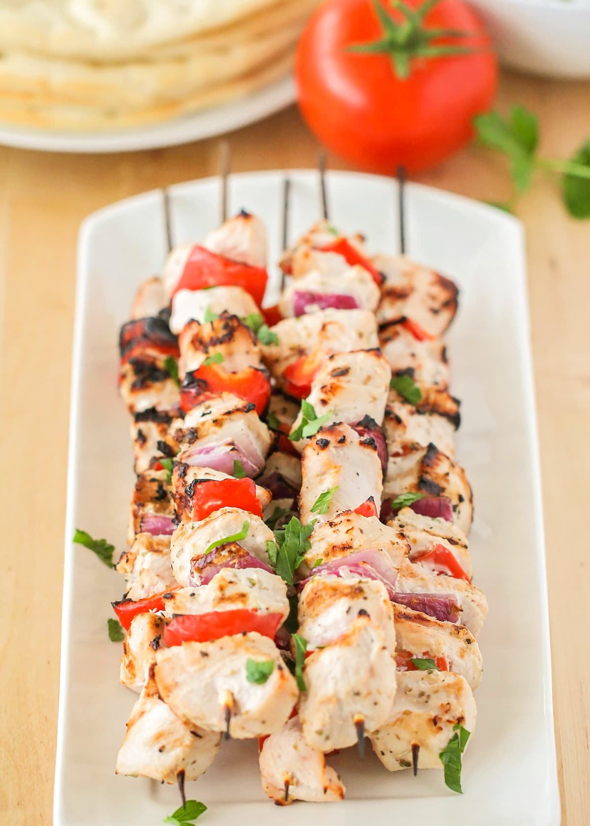 Chicken souvlaki recipe on skewers with veggies.